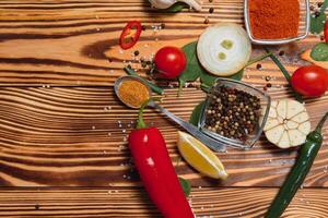 Cooking table. Background with spices and vegetables. Top view. Free space for your text. photo