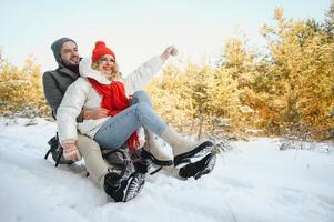 Two young people sliding on a sled photo