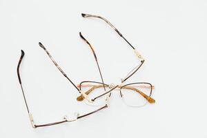 Stylish eyeglasses over background. Optical store, glasses selection, eye test, vision examination at optician, fashion accessories concept. Top view, flat lay photo