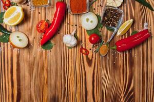 Cooking table. Background with spices and vegetables. Top view. Free space for your text. photo