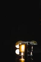 sabroso alcohol bebida cóctel tequila con Lima y sal en vibrante oscuro antecedentes. de cerca. foto