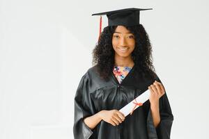 attractive female african american university graduate on white background photo