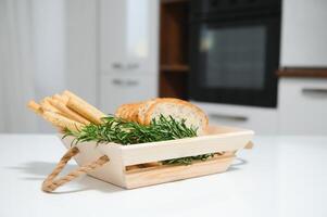 Craft wooden plate for storing bread or vegetables in the kitchen photo