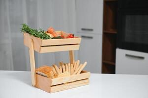 handmade kraft box with fruits and vegetables on kitchen background. photo