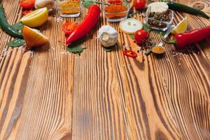 Cooking table. Background with spices and vegetables. Top view. Free space for your text. photo