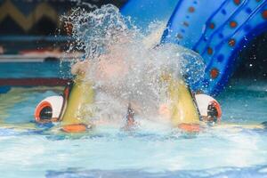 Boy having fun in aqua park photo