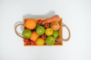 fruits in a wooden box in the kitchen. handmade box. photo