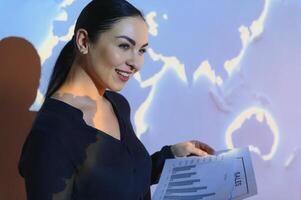Globe business concept - happy business woman with world map background. photo
