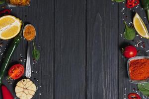 Cooking table. Background with spices and vegetables. Top view. Free space for your text. photo