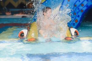 The boy is rolling with a water slide at a water park in Little Rock photo