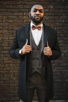 Portrait of an African American businessman wearing a suit standing in an outdoor business environment photo