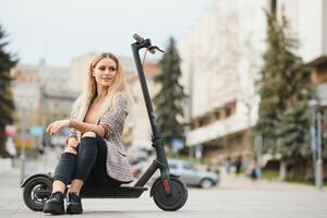 Portrait of a young woman with electro scooter photo