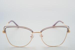 Female eyeglasses macro detail over a white background. Horizontal photo