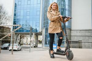 Portrait of a young woman with electro scooter photo