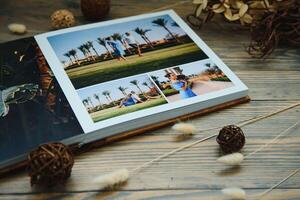 Luxury wooden photo book on natural background. Family memories photobook. Save your summer vacation memories.