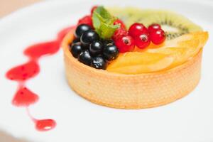 Delicious cheesecake with berries on table close up photo