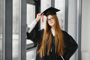 Woman portrait on her graduation day. University. Education, graduation and people concept. photo