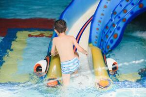 The boy is rolling with a water slide at a water park in Little Rock photo