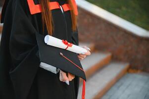 graduación estudiante en pie con diploma foto