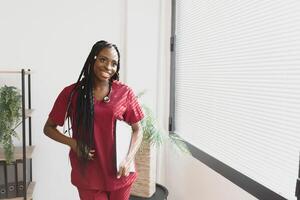 medicine, people and healthcare concept - african american female doctor or nurse at hospital. photo