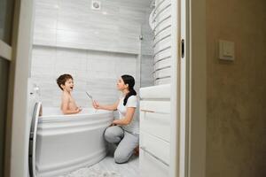 Mother And Son Having Fun At Bath Time Together photo