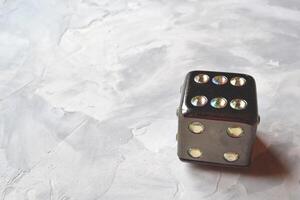 Dice cube with precious jewels on the table. Playing cube. photo