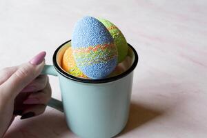 Easter egg in a cup. Beautiful easter background. Homemade holiday decor. photo