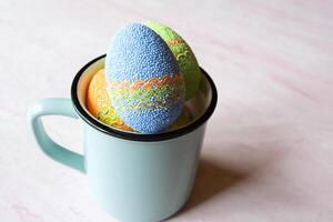 Easter egg in a cup. Beautiful easter background. Homemade holiday decor. photo