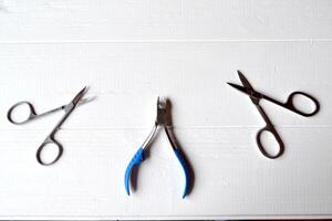 Tools for manicure. Manicure scissors on the white background. photo