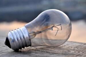 Light bulb in the water. Electricity lamp. photo