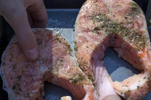 Preparation of trout in spices to roast on barbecue outdoor. photo