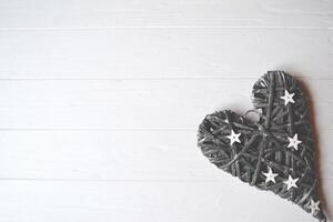 Grey heart on the white table. Background with place for text. Valentine's day card. photo