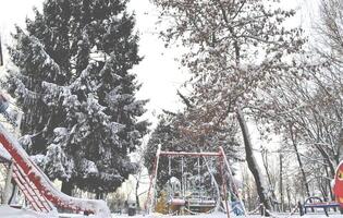 Winter playground kids. Snow in the street. Winter holiday. photo