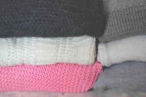 The shelf with knitted sweaters. Winter clothes photo