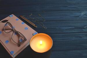 Stylish objects on the wooden table. Dark blue background with place for text. photo