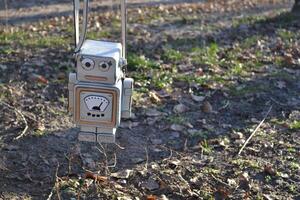 Bag in the form of a robot on the sand. photo