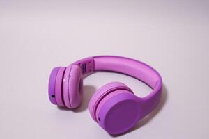 Purple headphones on a grey background. photo