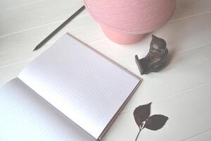 Pencil, lamp and dairy on the table. Beautiful workplace. photo