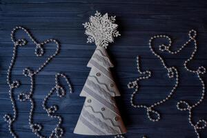 Christmas wooden background with attributes of New Year and Christmas Day. Cute background for card. Merry Christmas and Happy New Year. Minimalism background. Dark blue background. photo