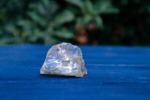 Citrine stone on a blue wooden background. photo