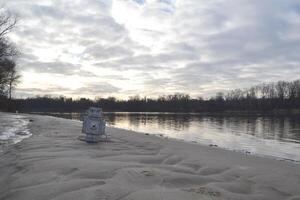 Bag in the form of a robot on the sand. photo