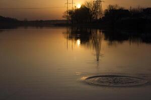 Sunset landscape. Pond at sunset time. Evening color of sky. photo