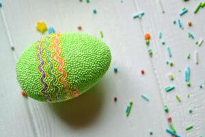 Colorful easter eggs bright sweet powder for easter cake on the white wooden table. Beautiful easter background. Easter card. Homemade holiday decor. photo