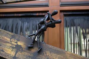 Little black manikins on a wooden boards. photo