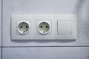 Electrical outlets and switch on wall. photo