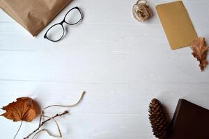 Craft paper, rope, box and eyeglasses on the white wooden background. Workshop tools. photo