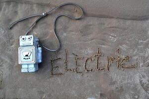 Bag in the form of a robot on the sand. photo