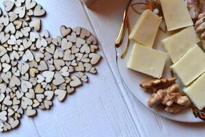 Morning coffee, tasty breakfast and decorative wooden hearts on the table. Hygge style background. photo