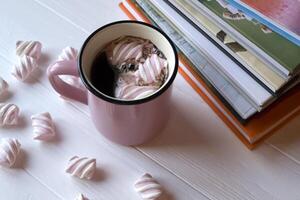 Books and coffee with marshmallow photo