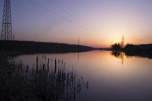 Sunset landscape. Pond at sunset time. Evening color of sky. photo